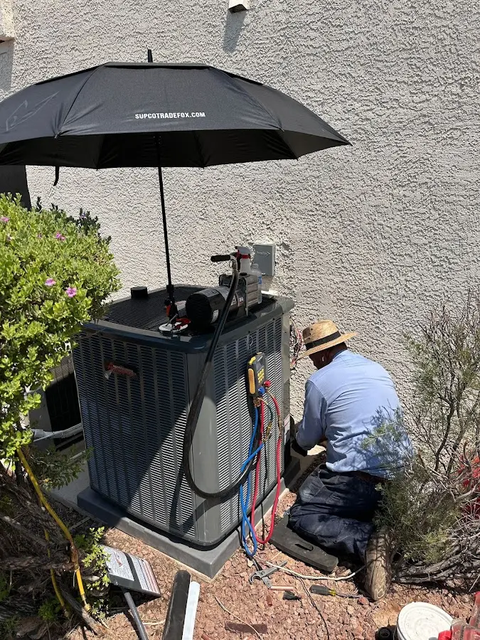 HVAC technician performing outdoor AC maintenance in Cairo